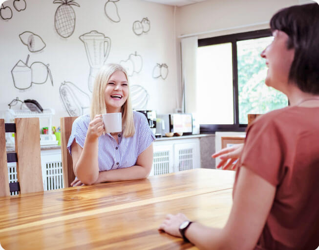 2 women drinking coffee and talking